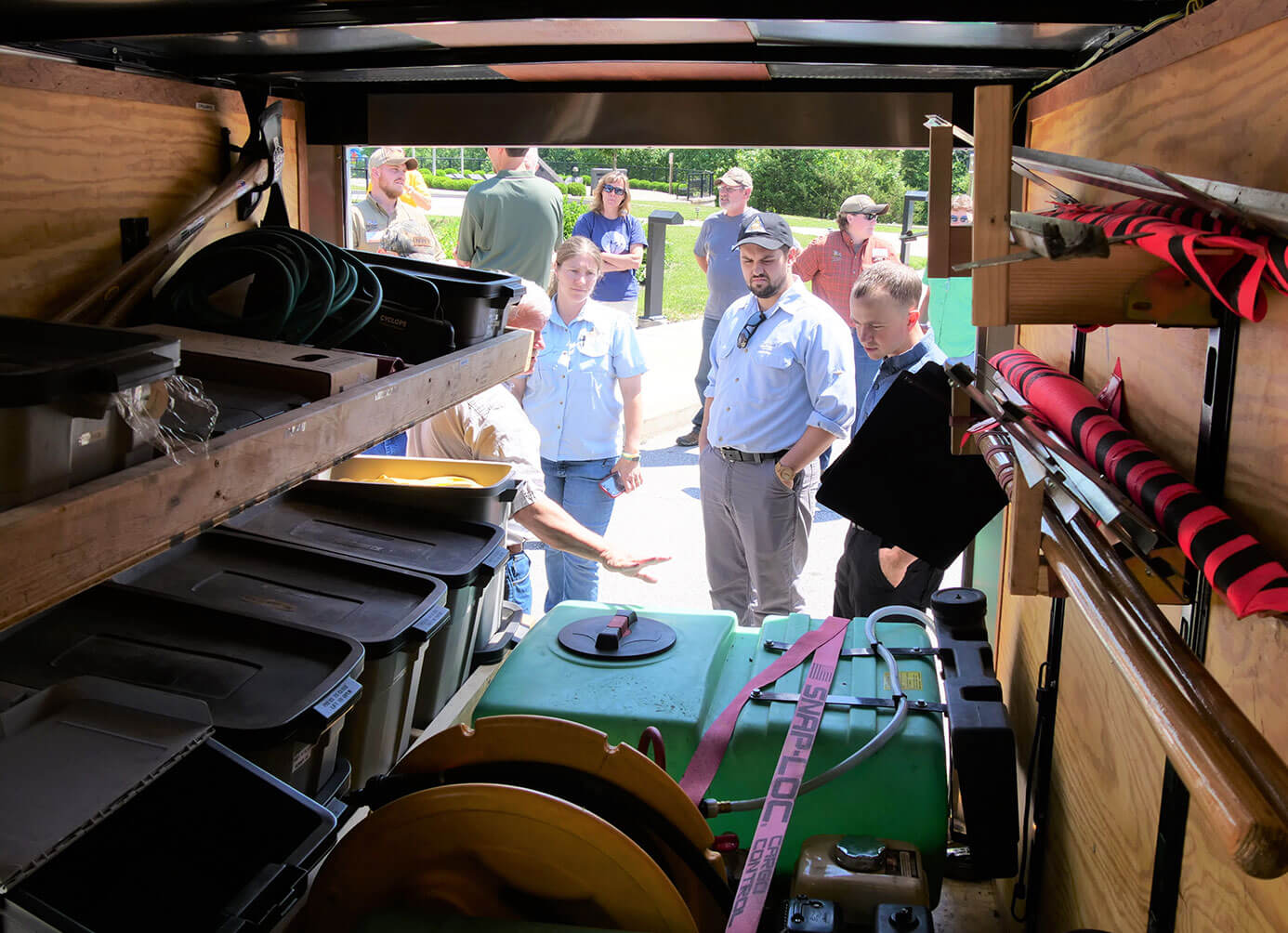 Workers looking inside of burn unit trailer filled with equipment 