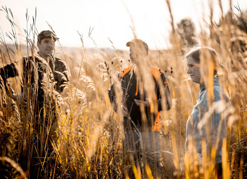 Workers conversing in a wheat field