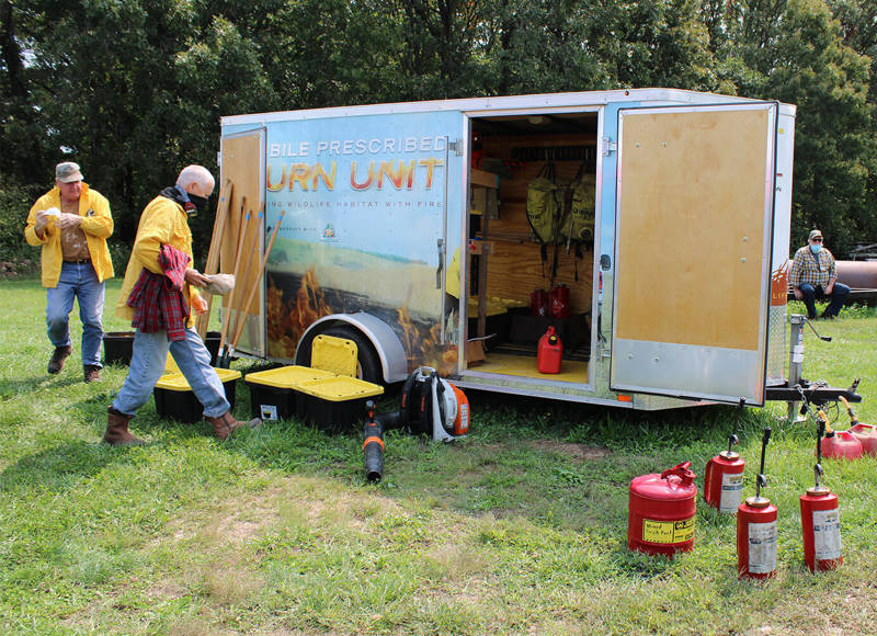 Burn unit trailer and workers in field