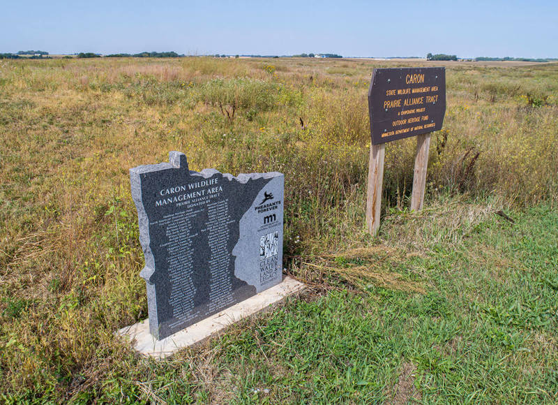 Two signs in a grassy field