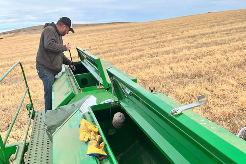 Farmer working on equipment in field